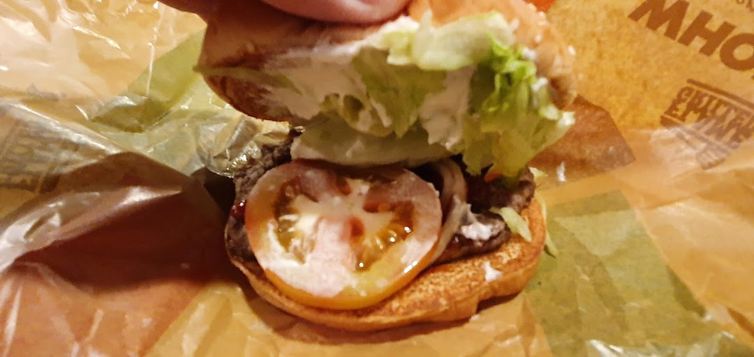 A close-up view of a Burger King burger, revealing its fresh ingredients.