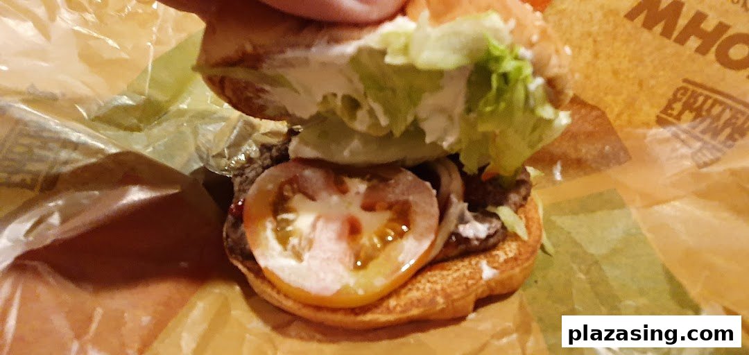 A close-up view of a Burger King burger, revealing its fresh ingredients.
