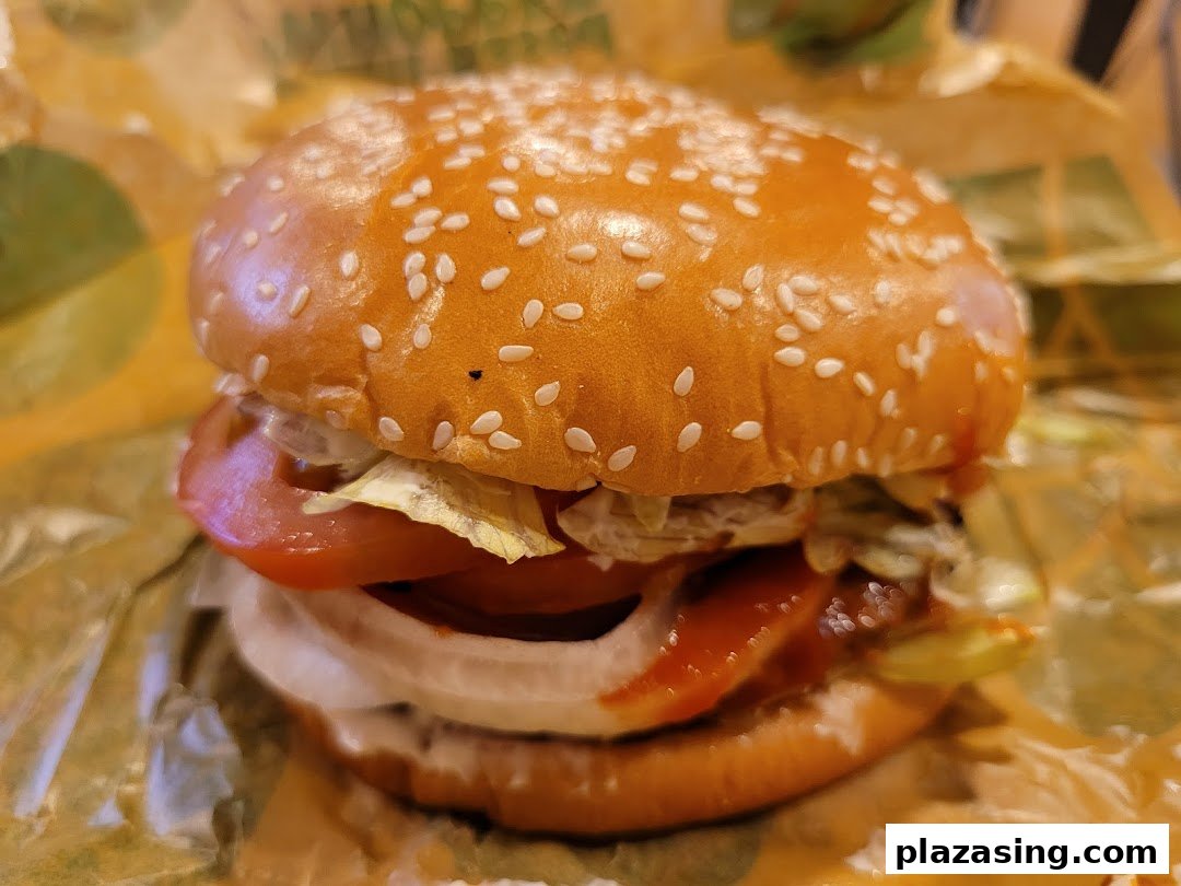 A close-up of a delicious Burger King burger with fresh ingredients on a sesame seed bun.