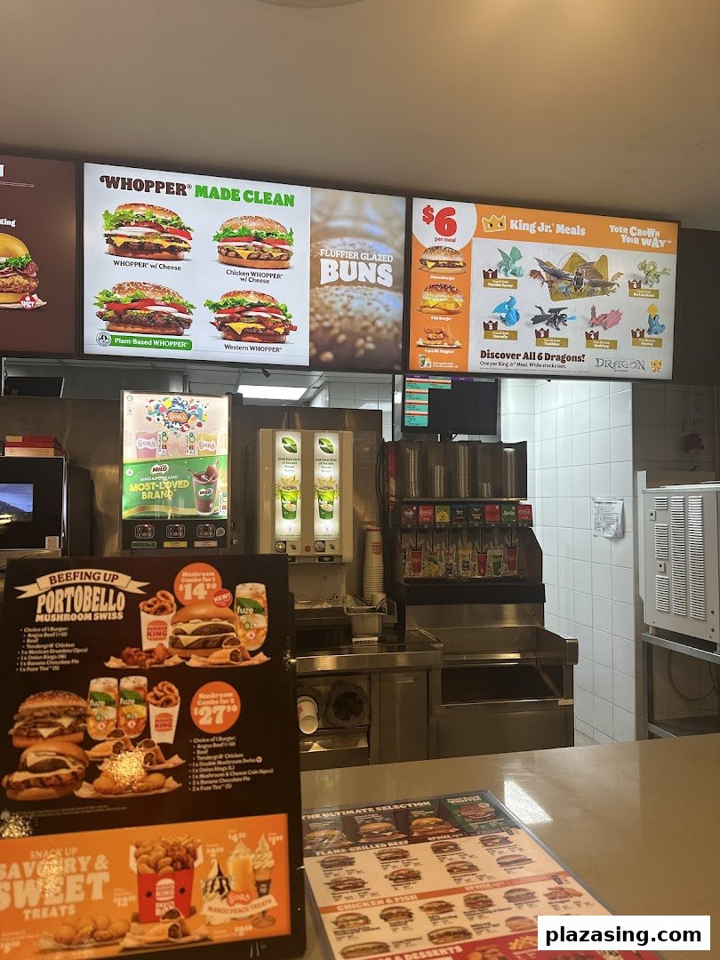 Interior view of Burger King with digital menu boards and counter displays showcasing burgers and combos.