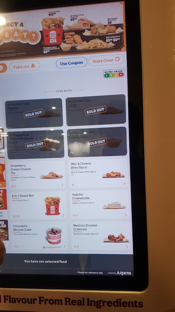 A self-service kiosk displaying Burger King's menu items, including sold-out options.