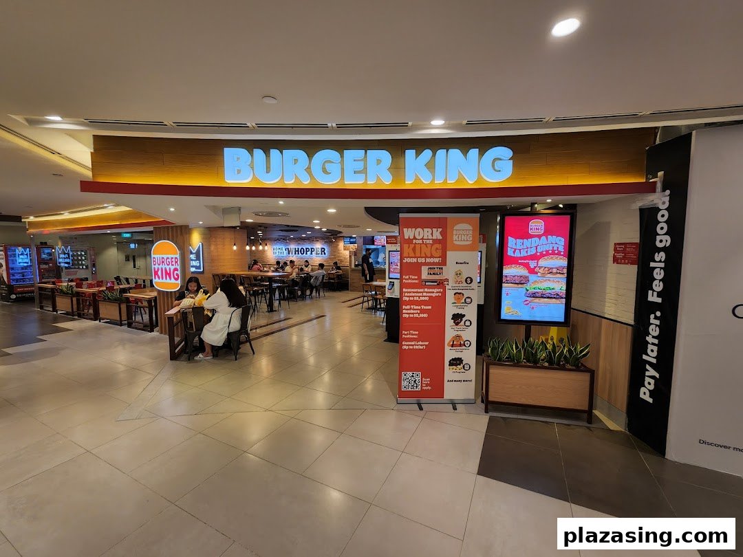 The inviting entrance of Burger King at Plaza Singapura, showcasing its vibrant branding and interior.