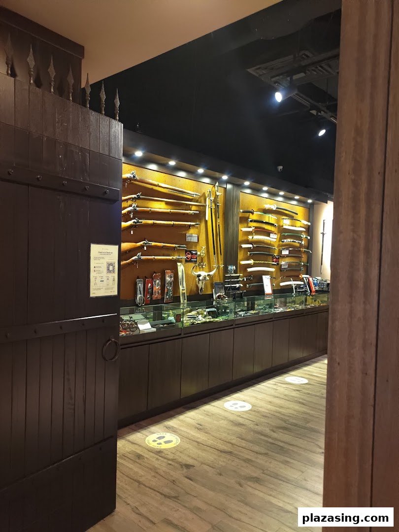Interior view of CAESARS Swords.Guns.Armour, showcasing a wide array of historical firearms, swords, and collectibles.