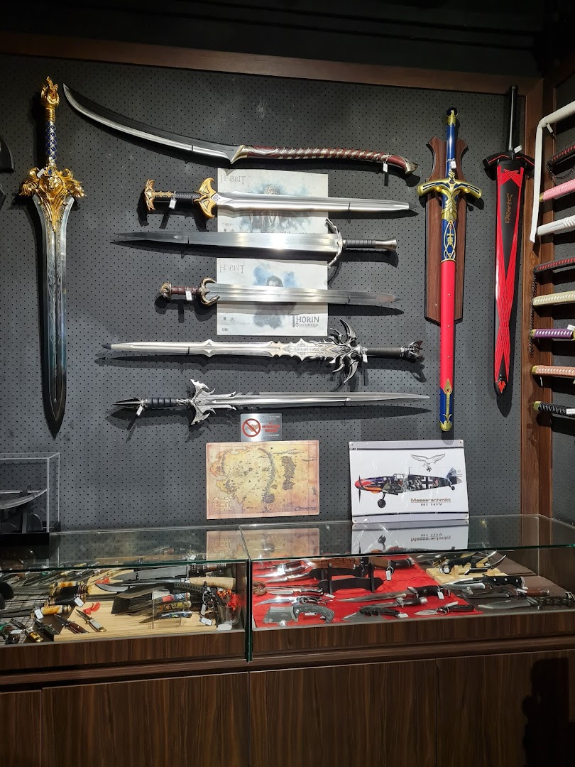 An interior shot of CAESARS Swords.Guns.Armour, showcasing a display of fantasy swords, knives, and collectibles.