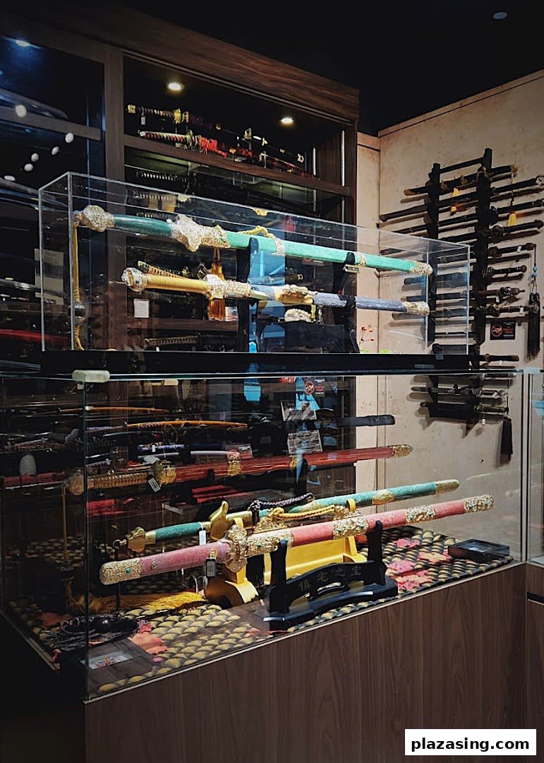 An interior view of 'CAESARS Swords.Guns.Armour' showcasing various decorative swords and blades in display cases.