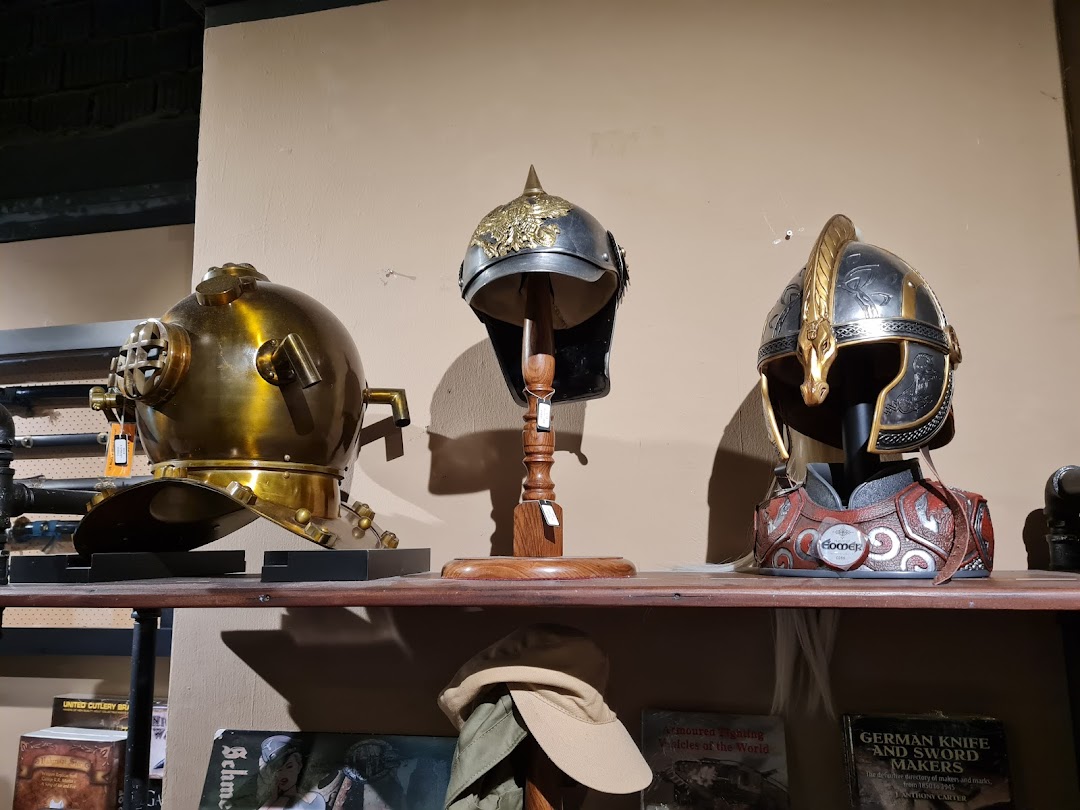 A display of unique helmets, including a vintage diving helmet and fantasy-inspired armor pieces.