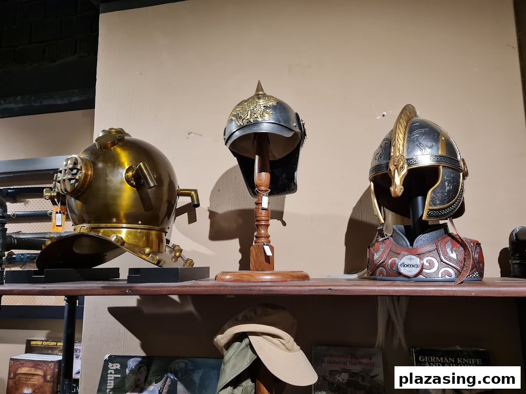 A display of unique helmets, including a vintage diving helmet and fantasy-inspired armor pieces.