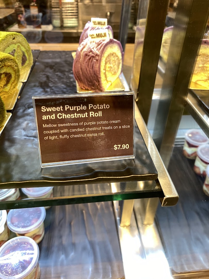 Close-up of a Sweet Purple Potato and Chestnut Roll with its detailed description and price tag in a display.