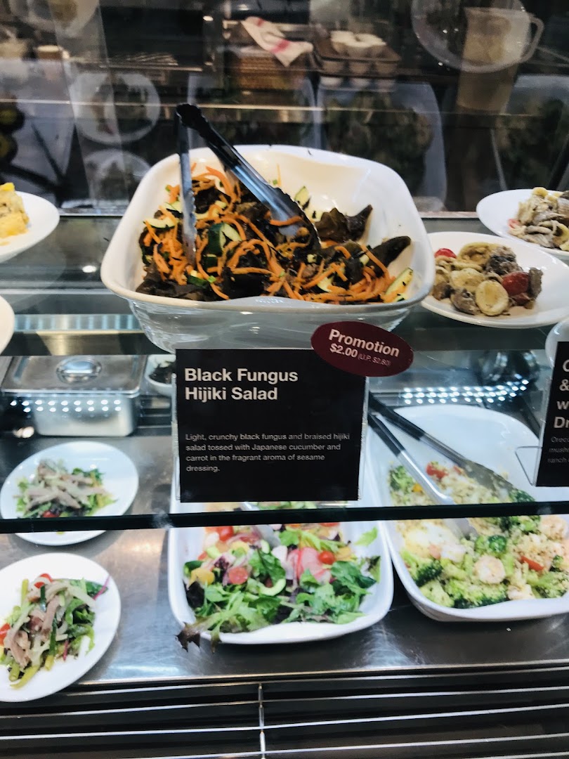 A display case showcasing fresh salads and prepared food items, including Black Fungus Hijiki Salad.