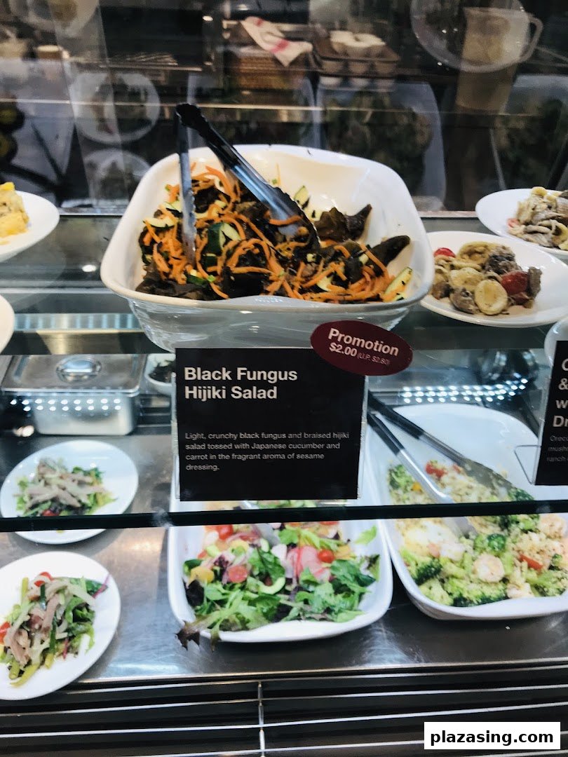 A display case showcasing fresh salads and prepared food items, including Black Fungus Hijiki Salad.