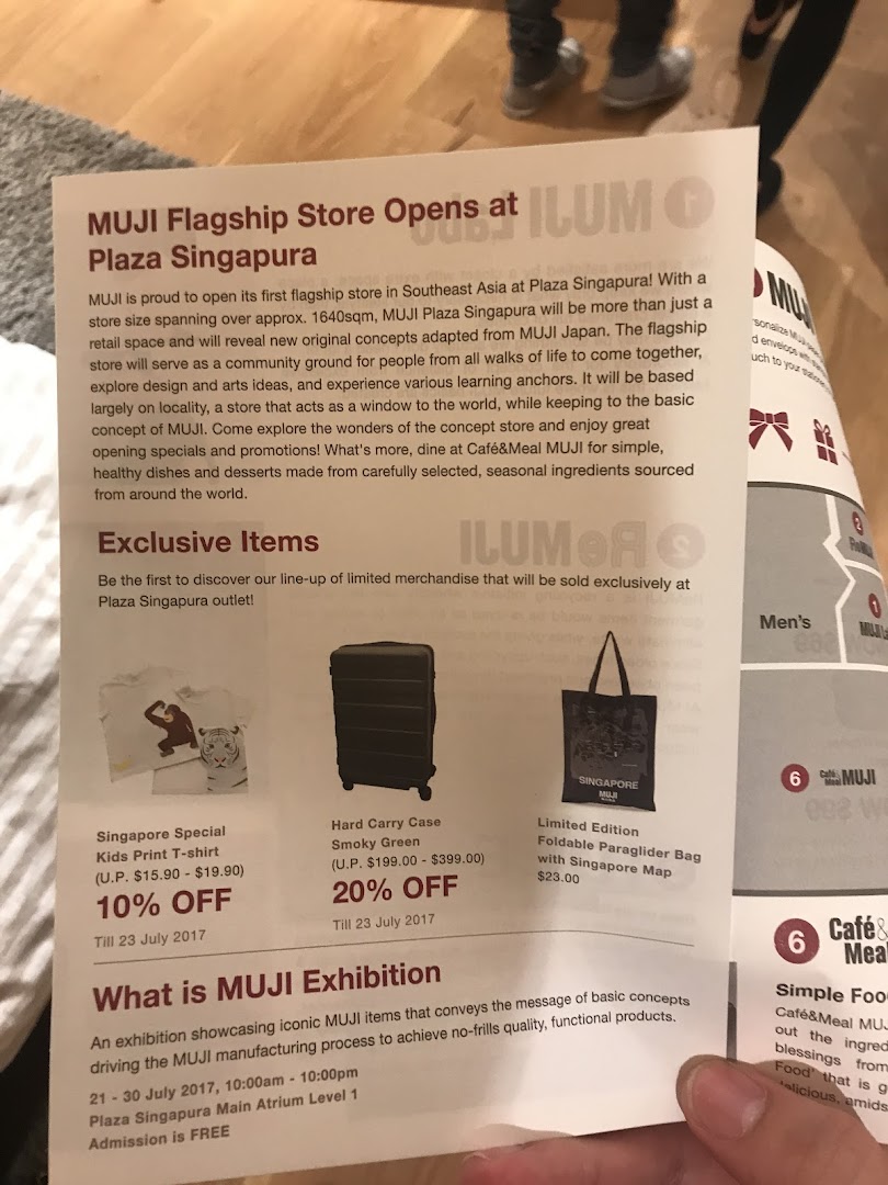 A promotional flyer announcing the grand opening of MUJI Plaza Singapura, highlighting exclusive items and the new Café&Meal MUJI.