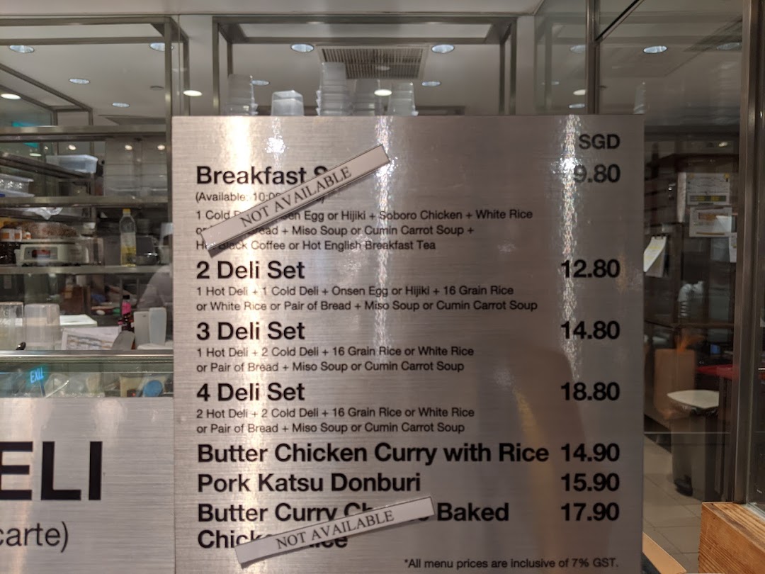 A detailed menu board displaying various food items and their prices at CafèMeal.