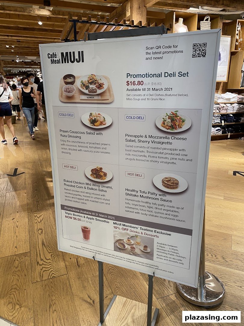 A promotional menu board for CafèMeal MUJI, showcasing deli sets, salads, and drinks.