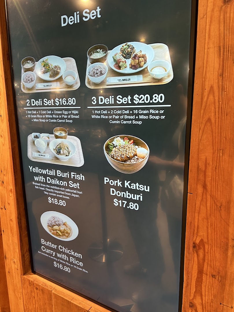 A digital menu board showcasing various deli sets and main dishes with prices at CafèMeal.