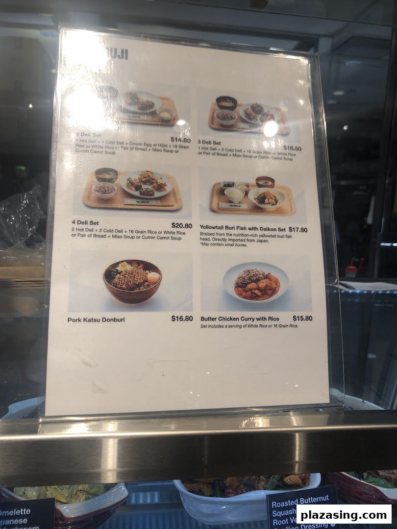 A detailed menu board displaying various deli sets and main dishes with prices at CafèMeal.
