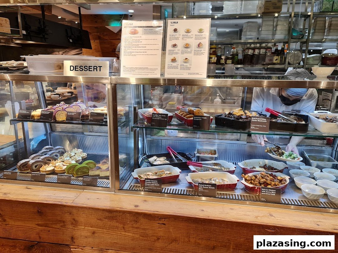 A vibrant display of freshly prepared desserts and hot dishes at CafèMeal MUJI's food counter.