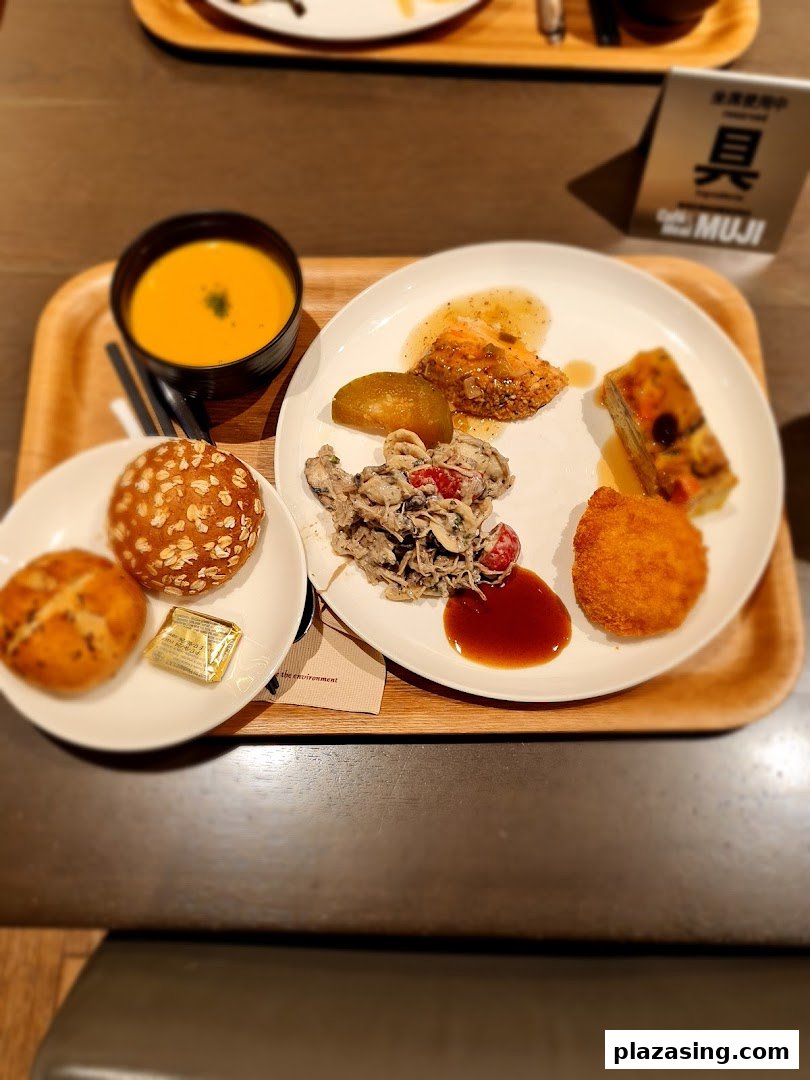 A beautifully presented meal on a wooden tray, featuring soup, bread, and various delectable dishes.