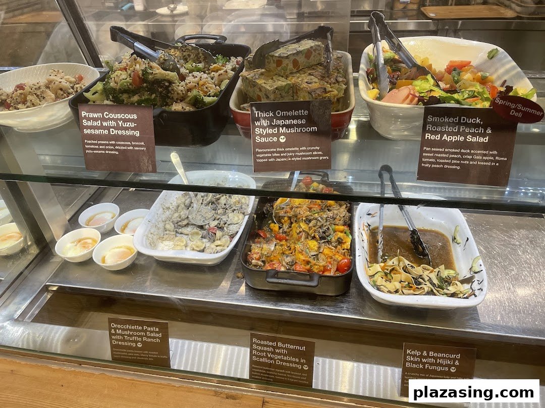 A vibrant display case showcasing a variety of fresh and healthy deli-style dishes at CafèMeal.