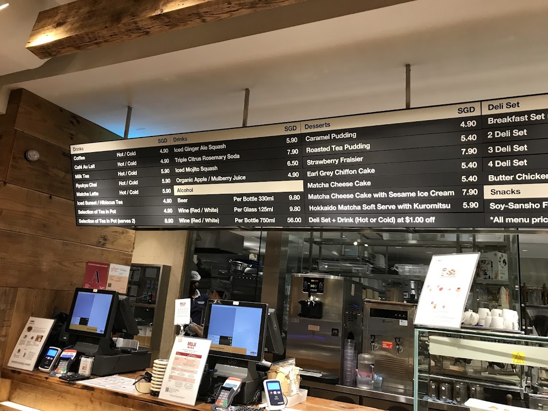 A digital menu board displaying a variety of drinks, desserts, and deli sets at CafèMeal.