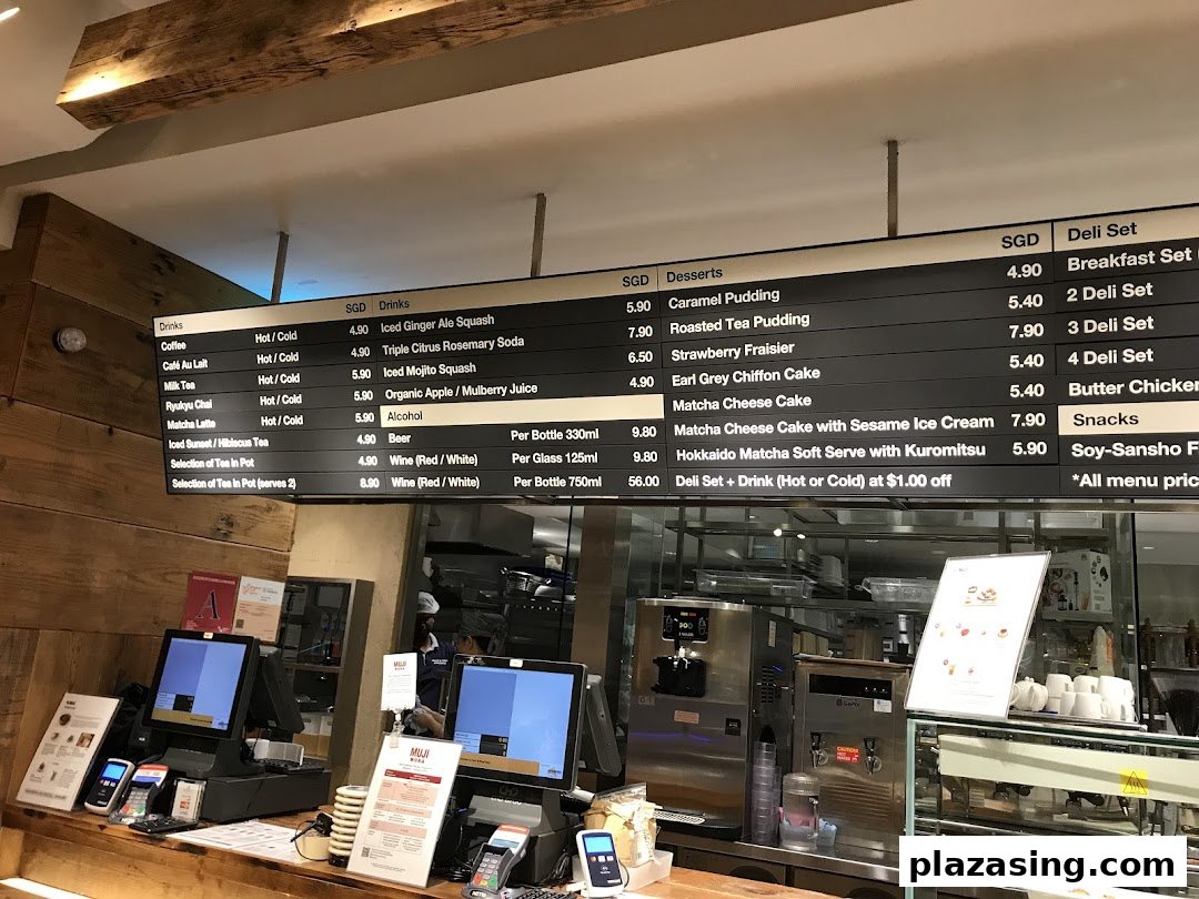 A digital menu board displaying a variety of drinks, desserts, and deli sets at CafèMeal.