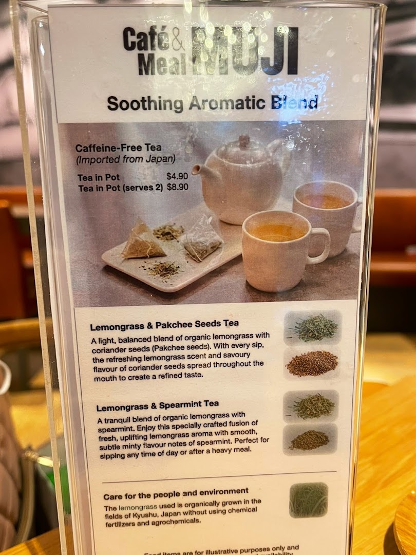 A close-up of a menu board from Café & Meal MUJI, featuring soothing aromatic tea blends.