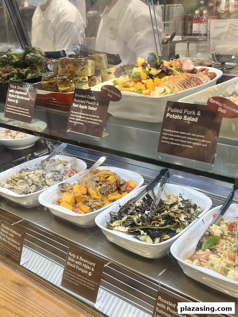 A vibrant display of fresh deli items and salads, including omelets, duck salad, and various vegetable dishes.