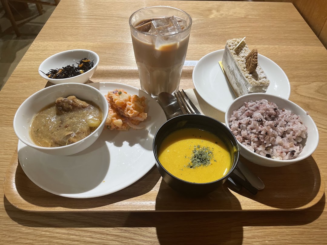 A delicious meal set with multiple dishes, a drink, and dessert on a wooden tray.
