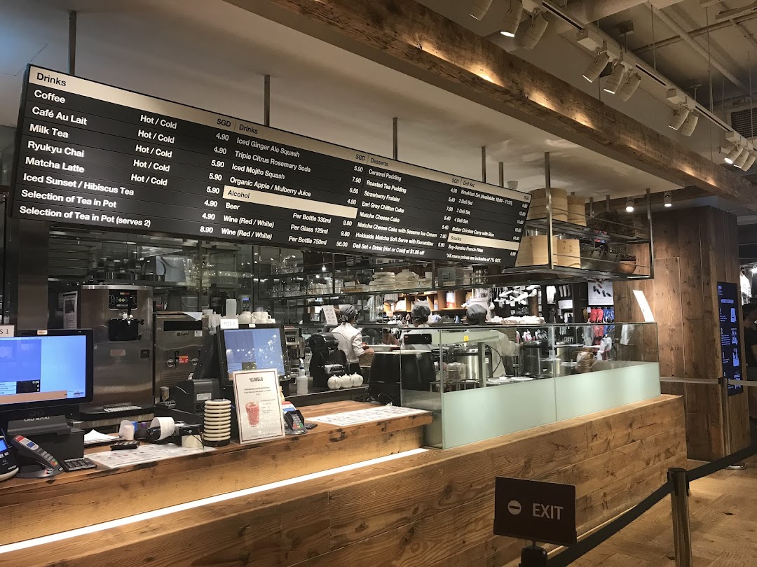 Interior view of CafèMeal with a large overhead menu board and service counter.