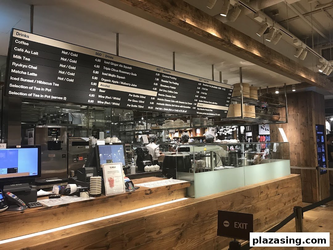 Interior view of CafèMeal with a large overhead menu board and service counter.