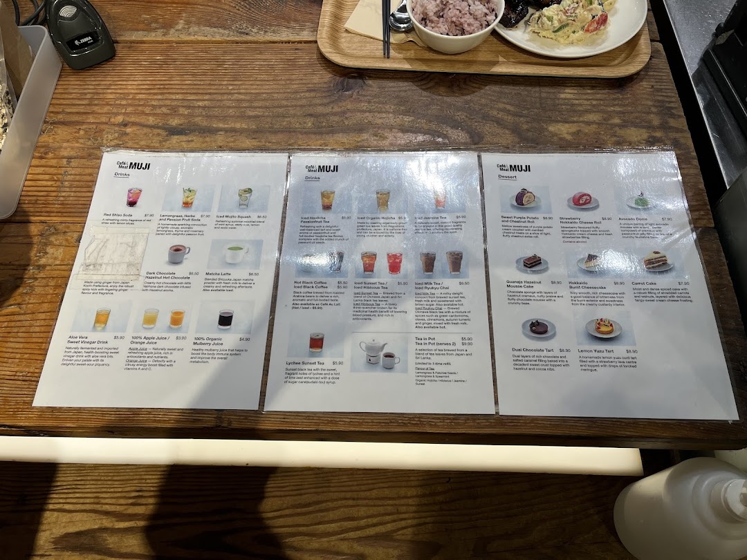 Three laminated menu sheets from Cafè&Meal MUJI showcasing a variety of drinks and desserts.