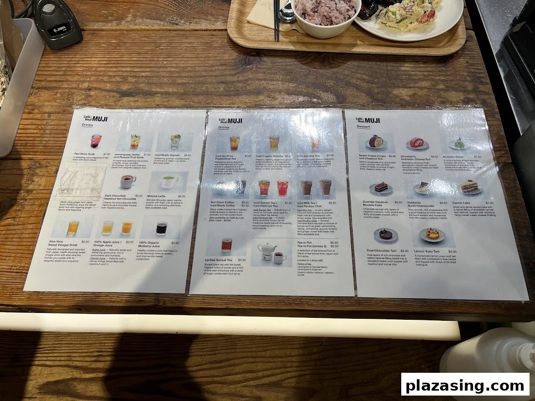 Three laminated menu sheets from Cafè&Meal MUJI showcasing a variety of drinks and desserts.