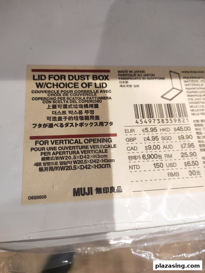 Close-up of a MUJI product label for a dust box lid, showing multi-language descriptions and international pricing.