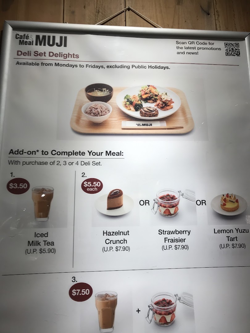 A menu board displaying Deli Set Delights and various add-on options for drinks and desserts at Café & Meal MUJI.