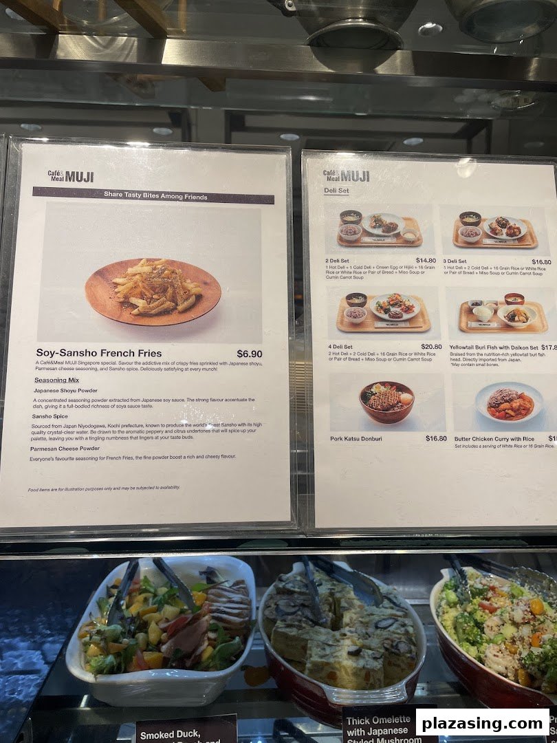 Close-up view of Café&Meal MUJI's menu boards displaying various Japanese-inspired dishes and deli sets.