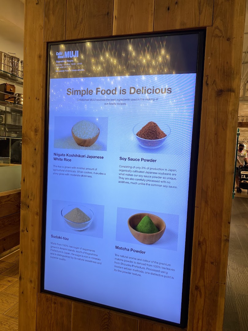 A digital display at Café&Meal MUJI showcasing the quality ingredients used in their dishes.