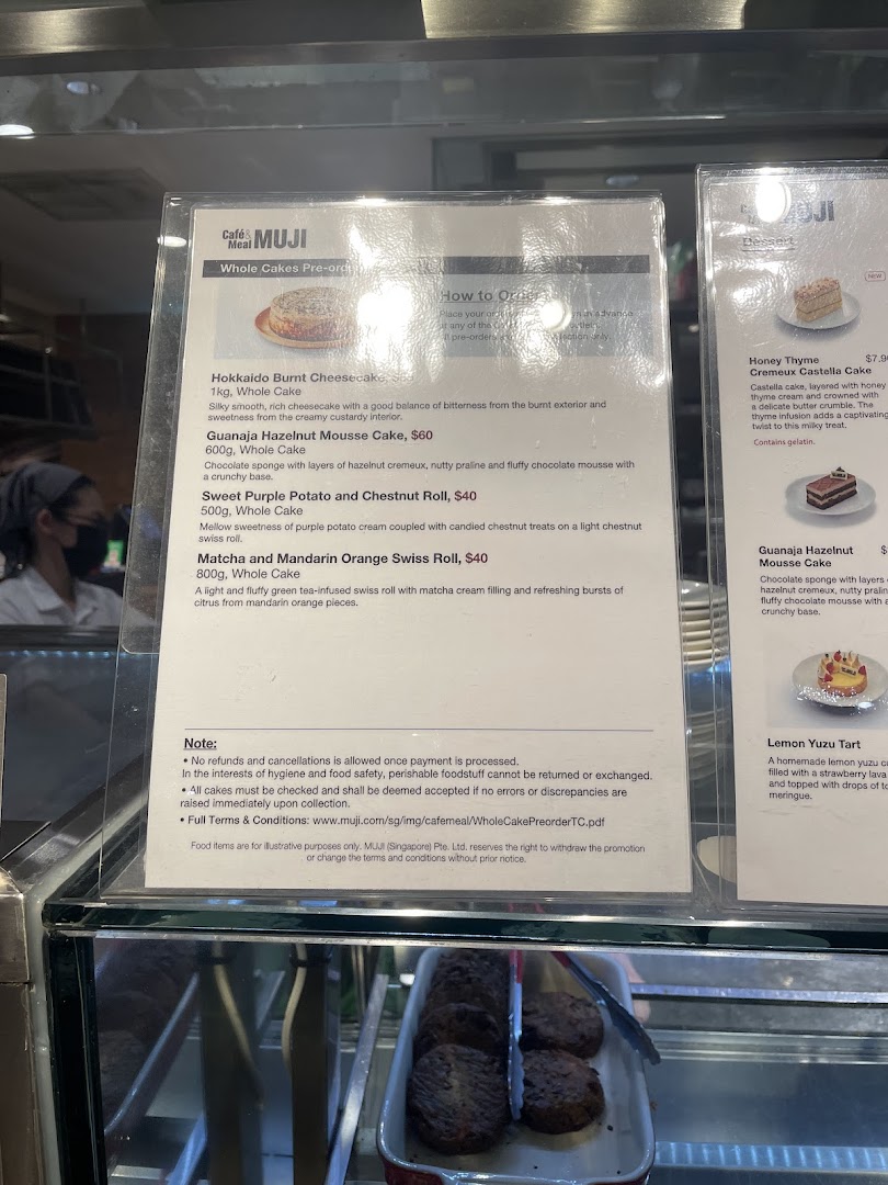 A close-up view of the menu display for whole cakes and desserts at Cafè&Meal MUJI.