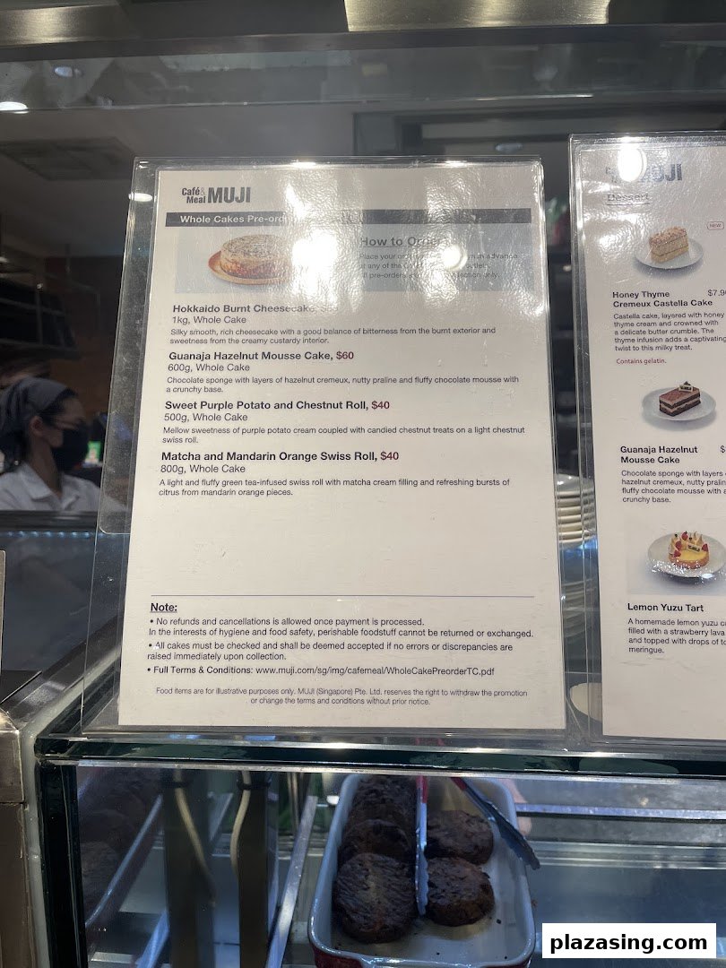 A close-up view of the menu display for whole cakes and desserts at Cafè&Meal MUJI.