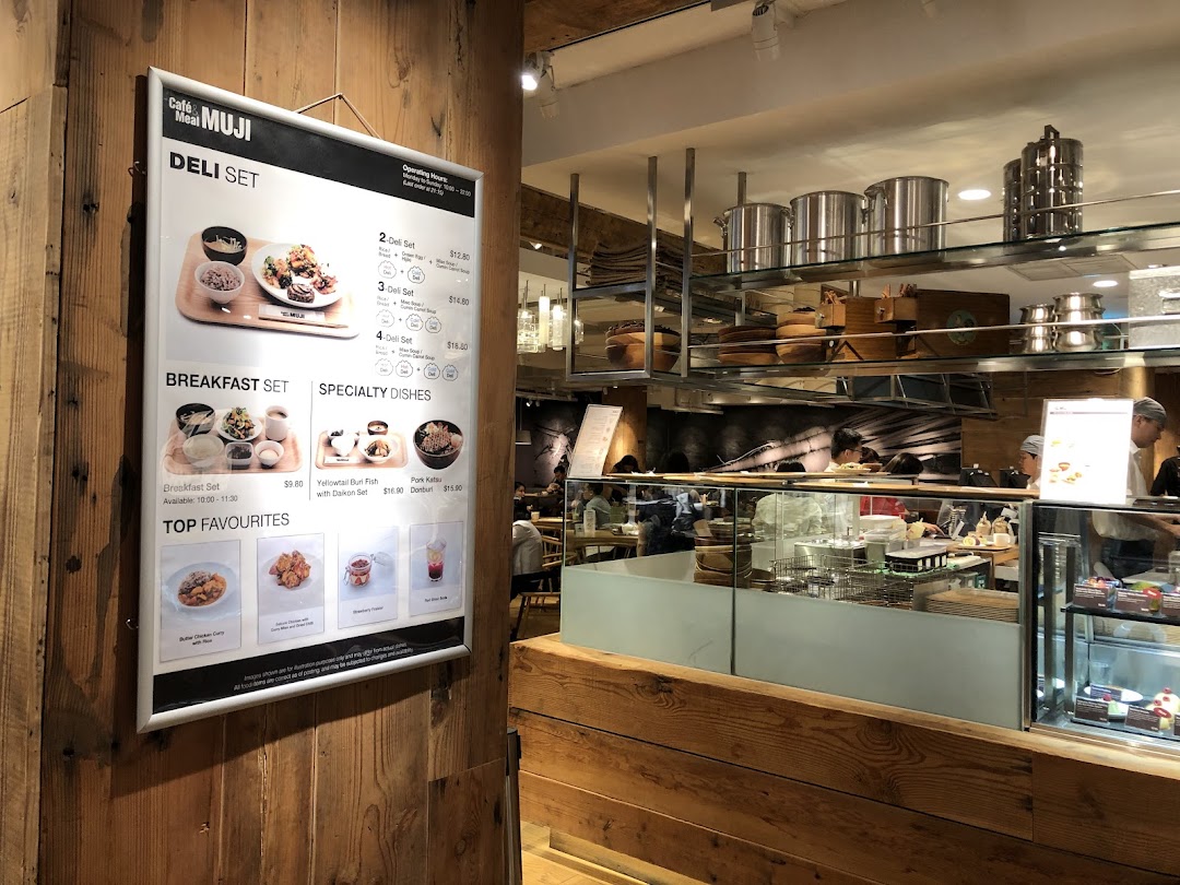 A large menu board for Cafe&Meal MUJI, showcasing deli sets, breakfast, and specialty dishes.