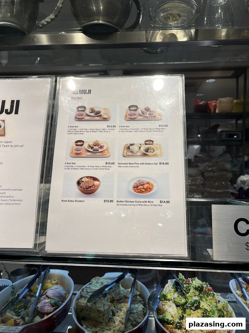 A menu board displaying various deli sets and main dishes with prices at CafèMeal MUJI.