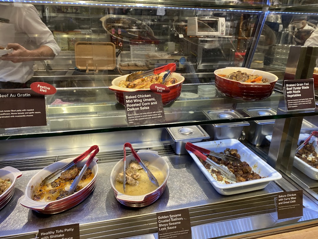 A vibrant display of freshly prepared hot dishes and deli items at CafèMeal.