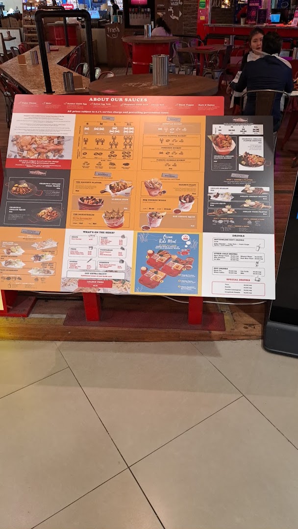 A large, colorful menu board for Cajun on Wheels, showcasing a variety of seafood and side dishes.