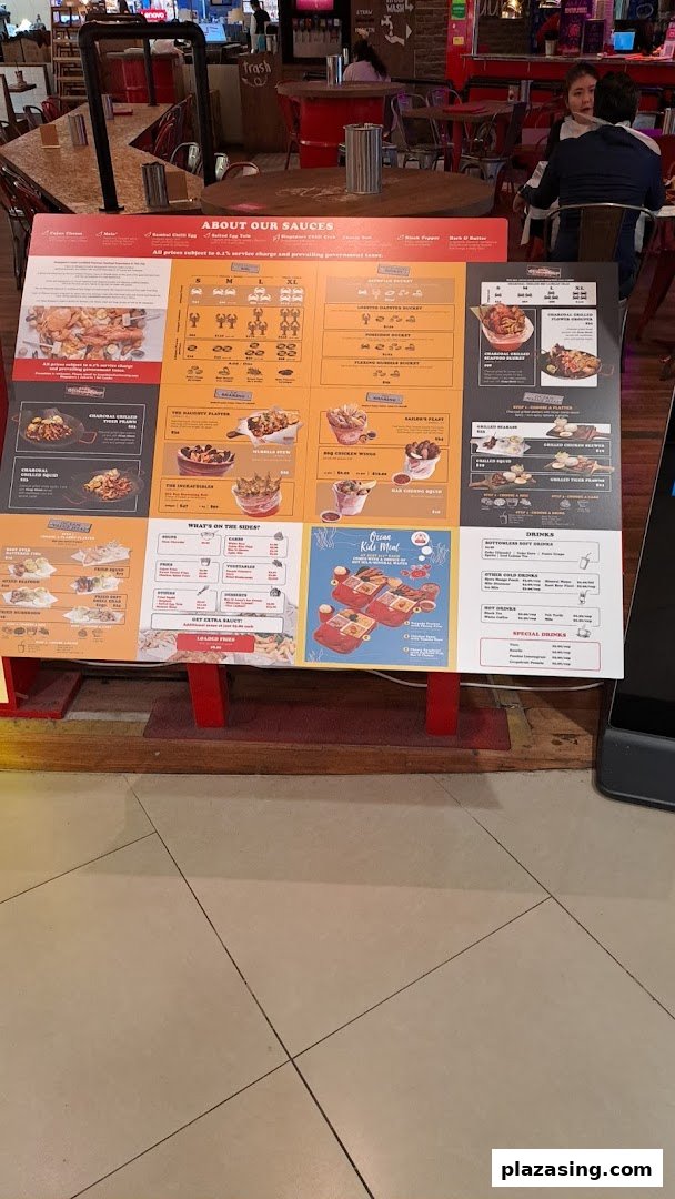 A large, colorful menu board for Cajun on Wheels, showcasing a variety of seafood and side dishes.