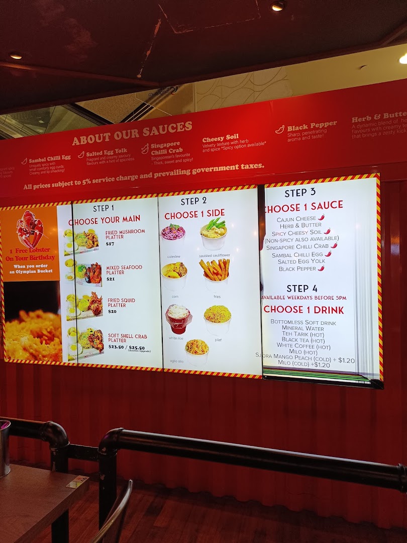 A digital menu board displaying customizable seafood platters, sauces, sides, and drinks.