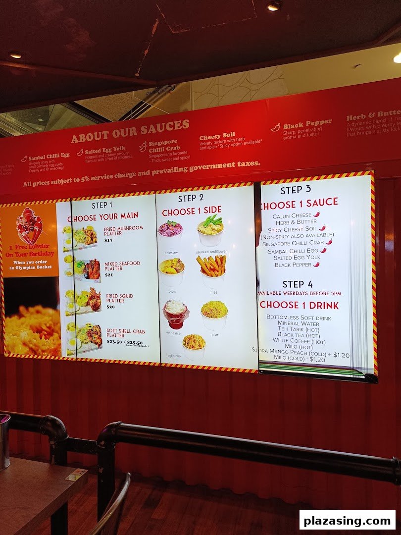 A digital menu board displaying customizable seafood platters, sauces, sides, and drinks.