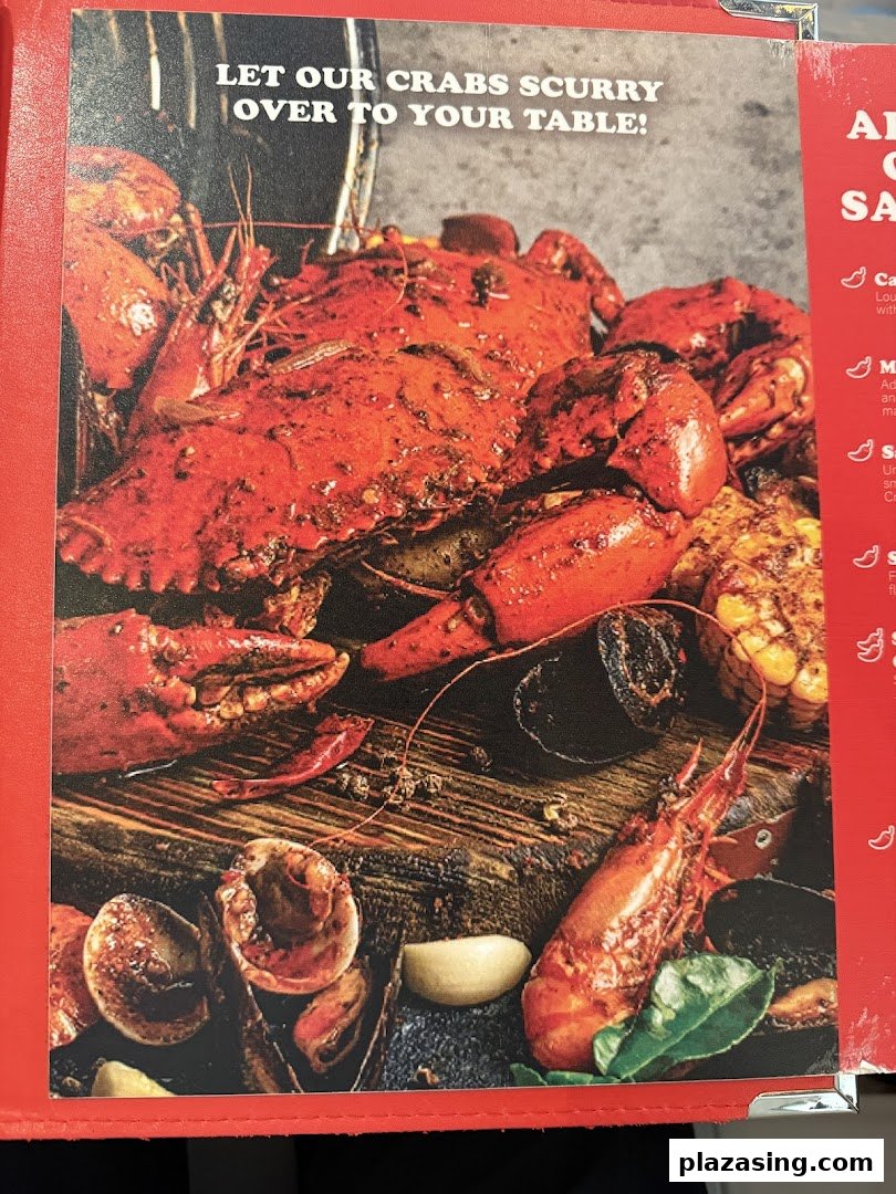 A vibrant close-up of a Cajun seafood boil featuring a large crab, shrimp, corn, and other ingredients.