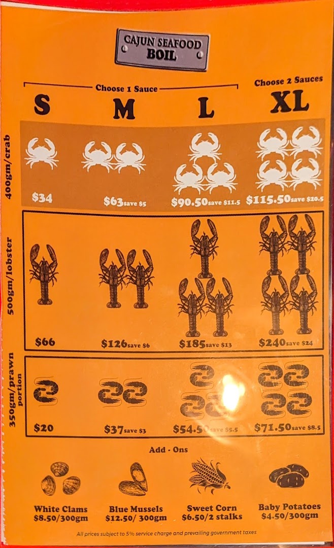 A vibrant orange menu displaying various Cajun seafood boil options and add-ons with prices.