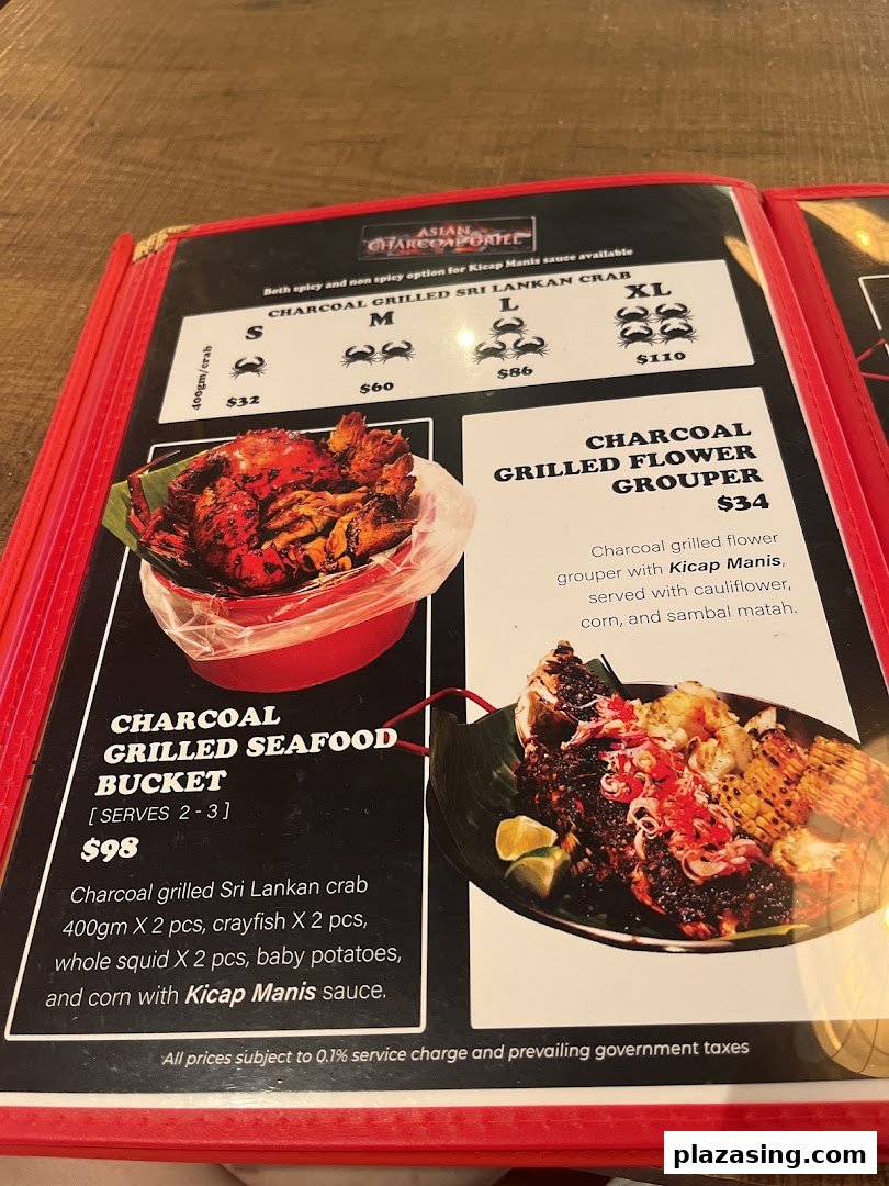 A close-up of a menu displaying charcoal-grilled seafood dishes and prices.