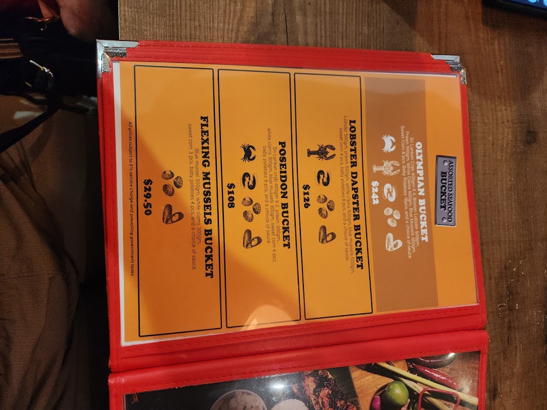 A close-up of a seafood restaurant menu displaying various bucket options and prices.