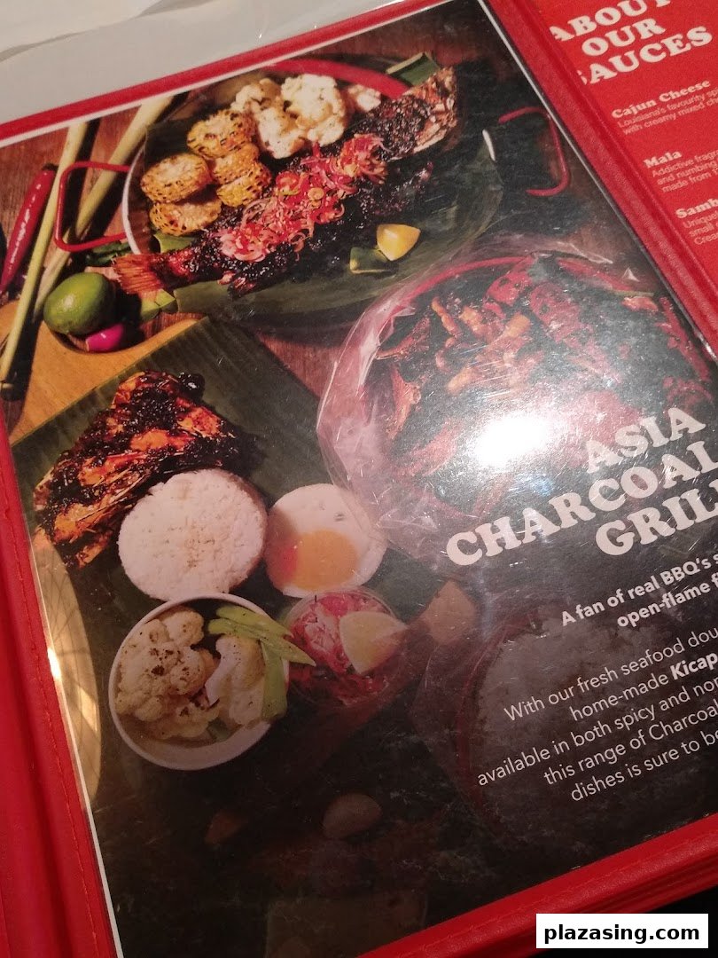A menu page showcasing grilled seafood and Asian charcoal grill dishes with sauce descriptions.