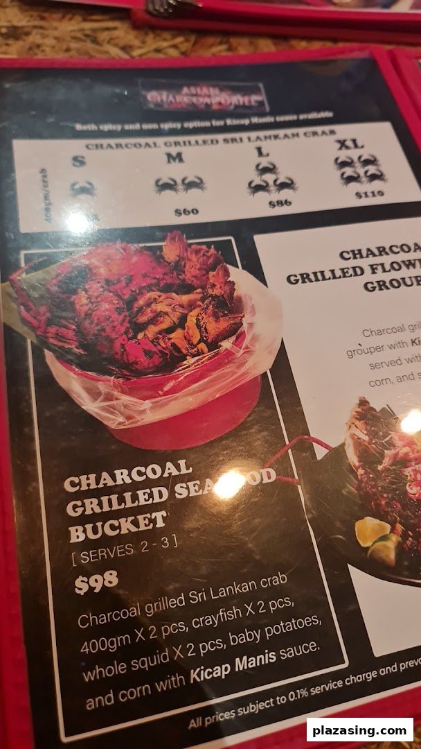 A close-up of a menu page featuring charcoal grilled seafood dishes and prices.